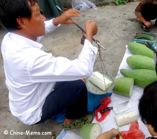 China Local Street Market , Man Using Scale